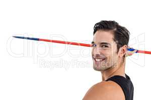 Portrait of happy male athlete holding javelin