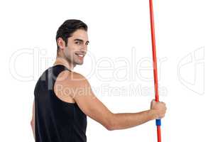Portrait of happy male athlete holding javelin