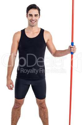 Portrait of happy male athlete holding javelin