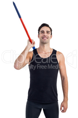 Happy male athlete holding javelin