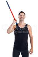 Happy male athlete holding javelin