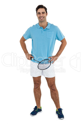 Portrait of badminton player standing with hands on hips