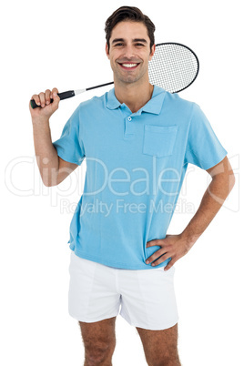 Portrait of badminton player standing with hand on hip