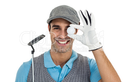 Golf player showing golf ball and holding golf club