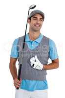 Happy golf player standing with golf ball and golf club