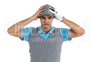Frustrated golf player standing on white background