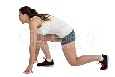 Athlete woman in ready to run position