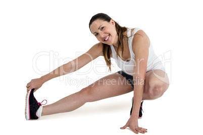 Happy athlete woman stretching her hamstring