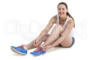 Portrait of athlete woman tying her running shoes