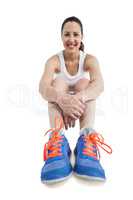 Portrait of athlete woman sitting with sports shoes