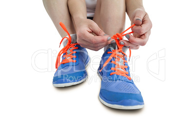 Portrait of athlete woman tying her running shoes