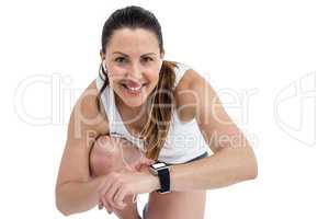 Portrait of athlete woman checking time in wrist watch