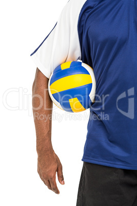 Mid-section of sportsman holding a volleyball