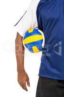 Mid-section of sportsman holding a volleyball