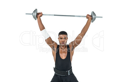 Portrait of bodybuilder lifting heavy barbell weights