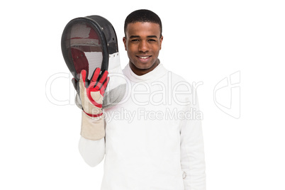 Swordsman holding fencing mask