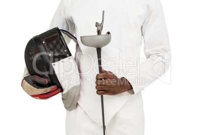 Mid-section of man standing with fencing mask and sword
