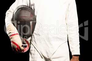 Mid-section of man standing with fencing mask