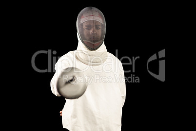 Man wearing fencing suit practicing with sword