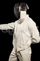 Man wearing fencing suit practicing