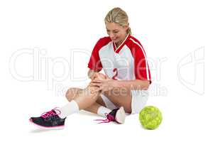 Sportswoman touching her knee