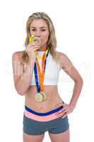 Happy athlete kissing medal