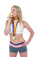 Happy athlete kissing medal