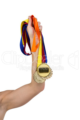 Athlete holding gold medals after victory