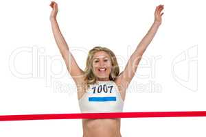 Portrait of cheerful winner athlete crossing finish line