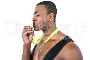 Happy athlete kissing medal
