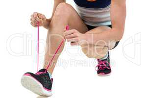 Athlete tying her shoe lace