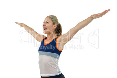 Excited female athlete with arms outstretched