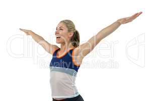 Excited female athlete with arms outstretched