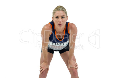 Tired athlete standing with hand on knee