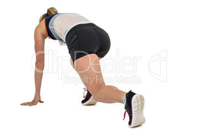 Female athlete in position ready to run