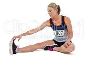 Athletic woman stretching her hamstring