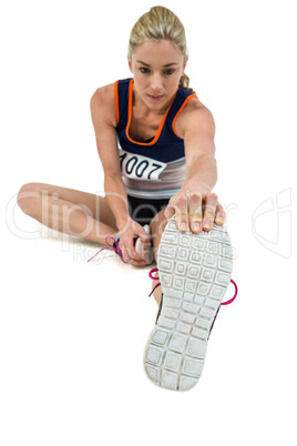 Athletic woman stretching her hamstring