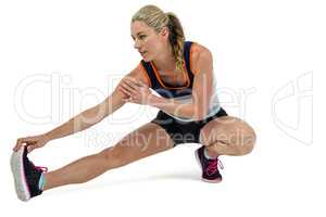 Athletic woman stretching her hamstring