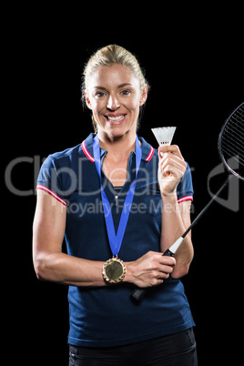 Badminton player posing with gold medal around his neck