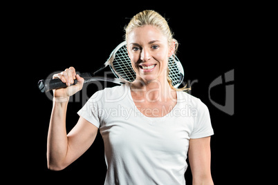 Portrait of female tennis player posing with racket