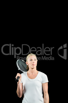 Female tennis player posing with racket