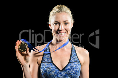 Female athlete posing with gold medal around his neck