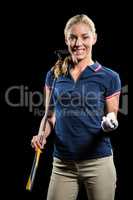 Portrait of golf player holding a golf club and golf ball
