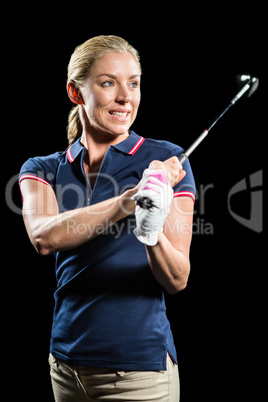 Golf player about to swing a golf ball