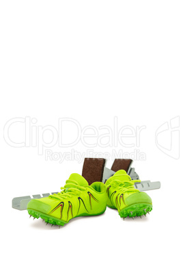 Trainer shoes and starting block on white background