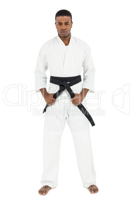 Fighter tightening karate belt