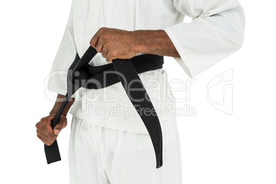 Fighter tightening karate belt