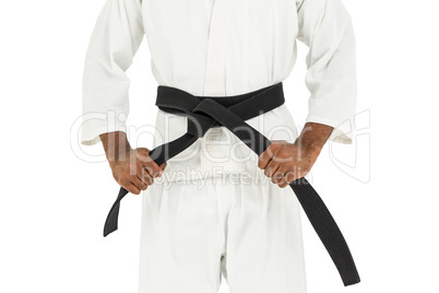 Fighter tightening karate belt