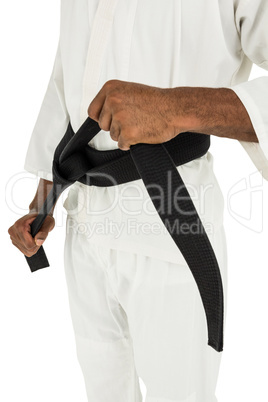 Fighter tightening karate belt