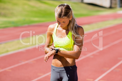 Female athlete checking her smart watch